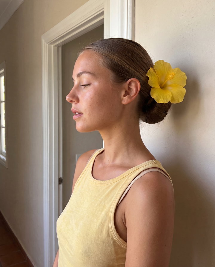 Young Woman in Profile with Yellow Flower