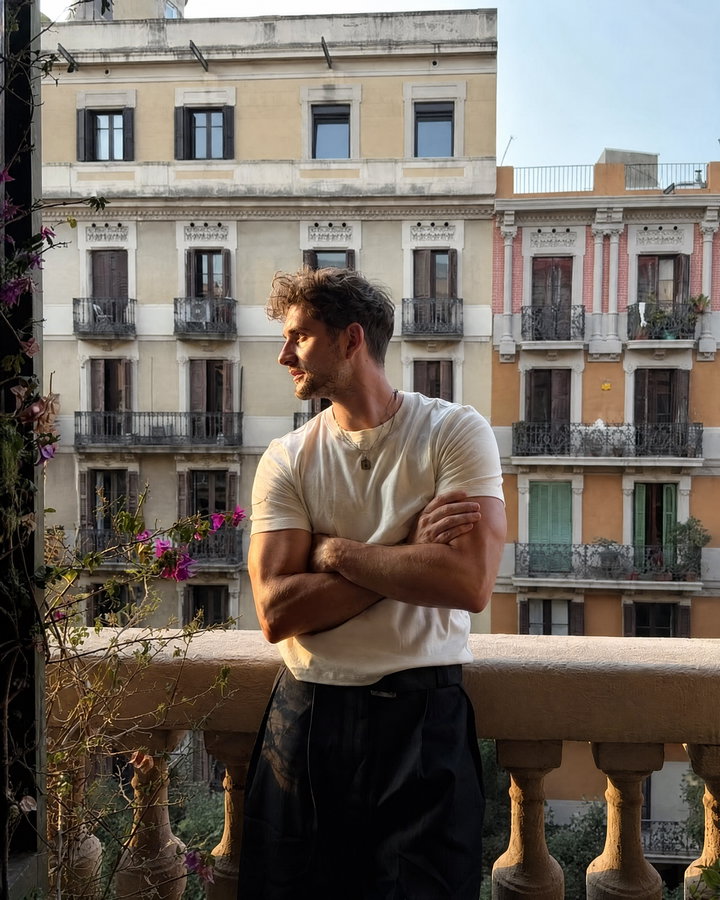 Young Man on Balcony Overlooking Urban Scene