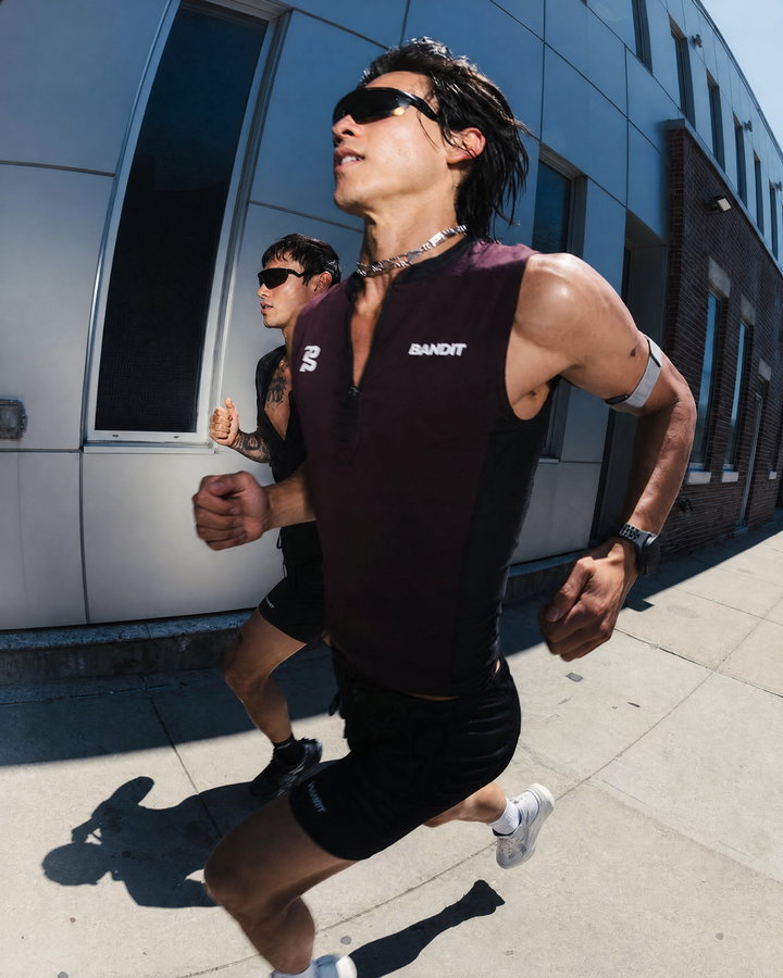 Athletic Duo Running on Urban Street