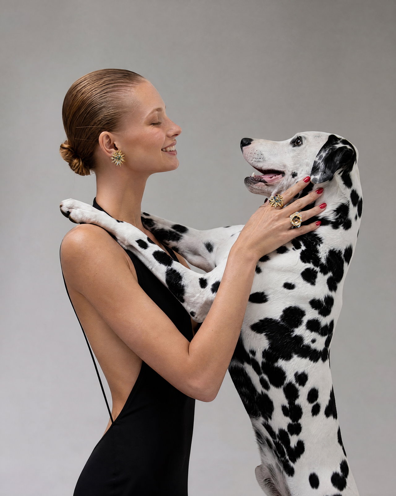 Fashion Model Interacting with Dalmatian Dog