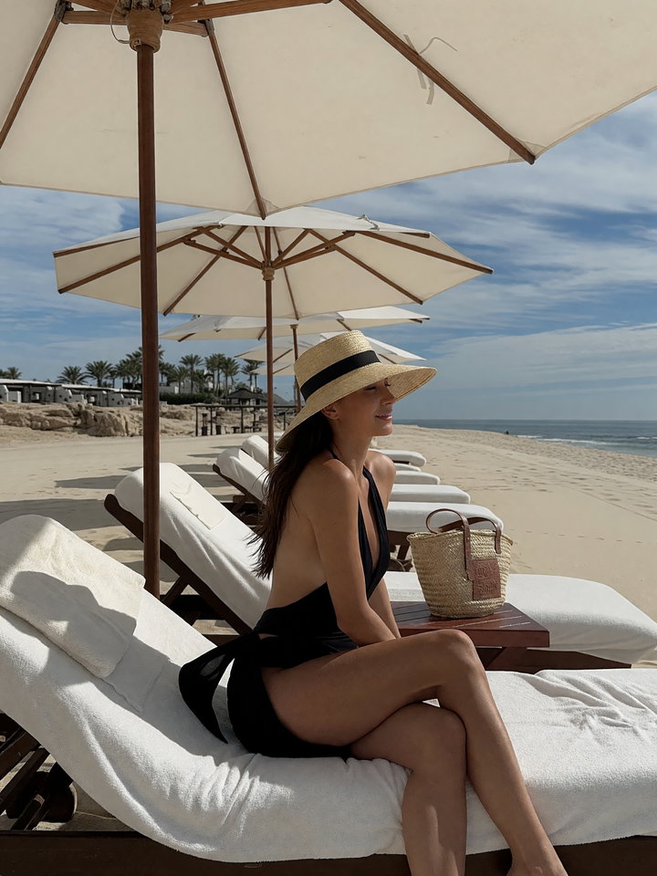 Person Lounging on Beach Sunbed