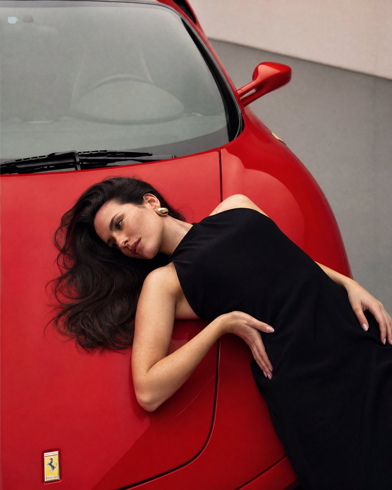 Fashion Model Reclining on Red Sports Car