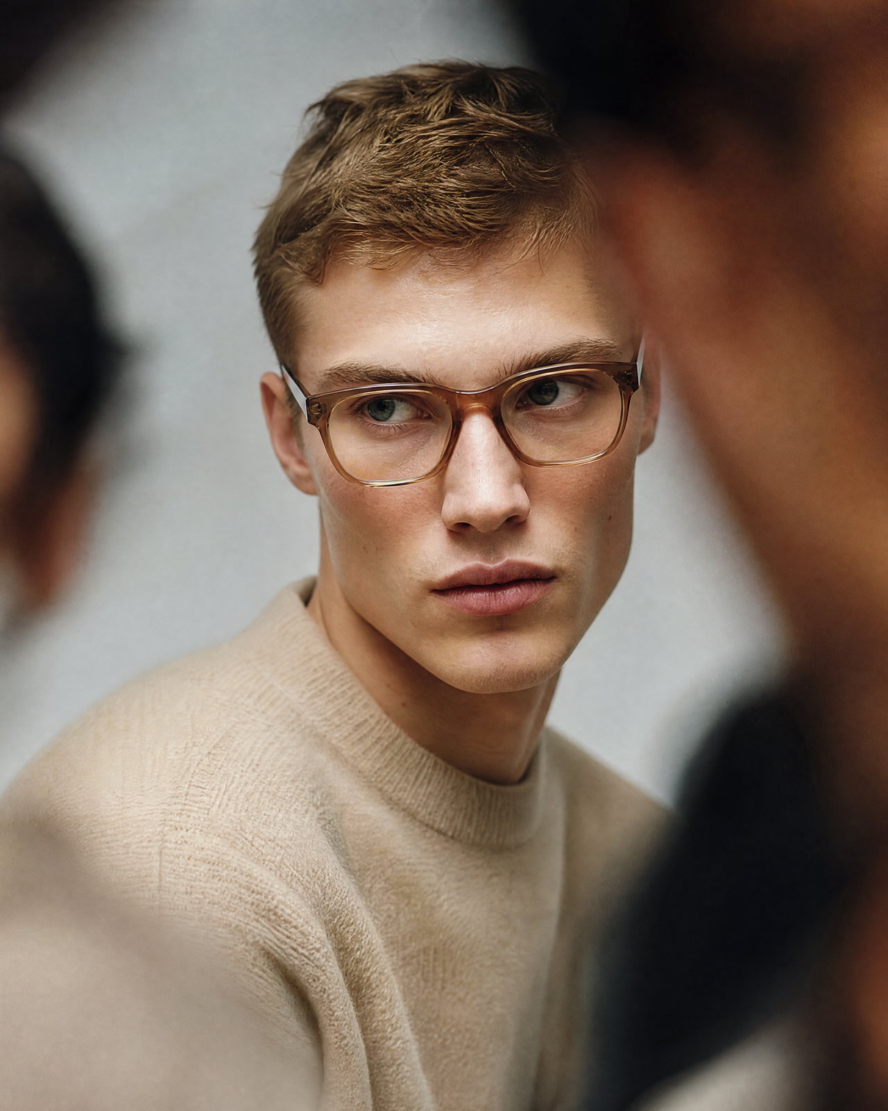 Contemplative Young Male Model in Beige Sweater