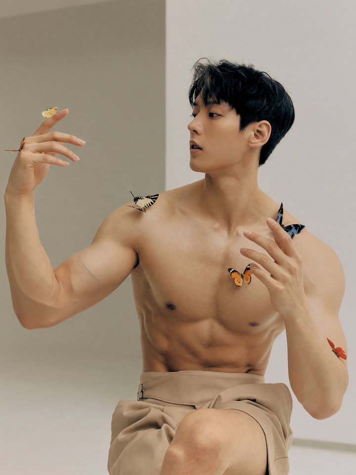 Fashion Model in Minimalist Studio with Butterflies