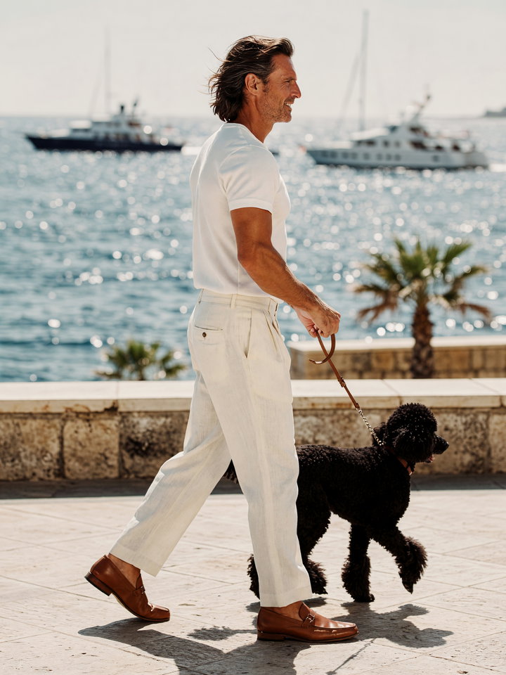 Man Walking Dog Along Sunlit Waterfront Promenade