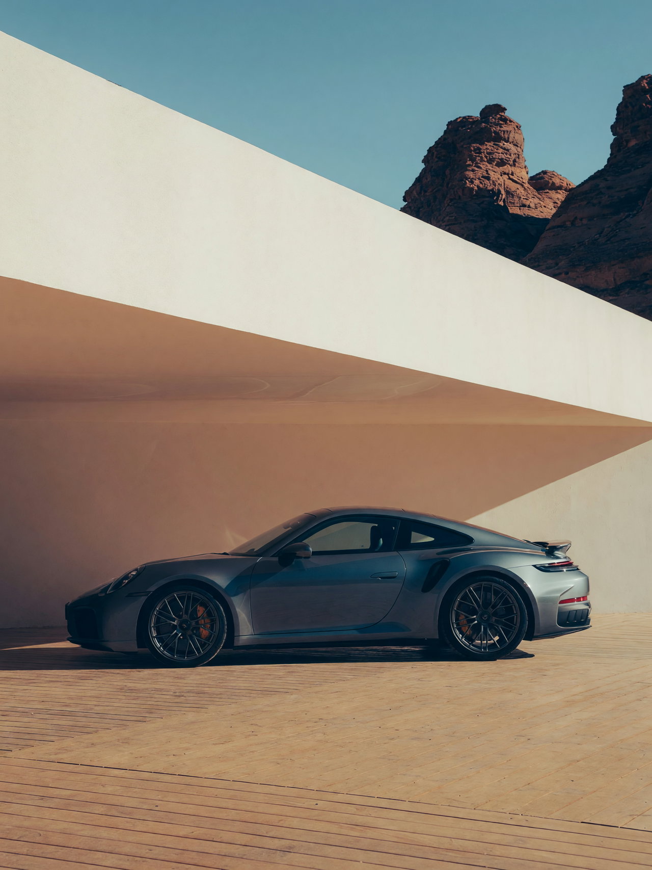 Sleek Gray Sports Car on Wooden Deck