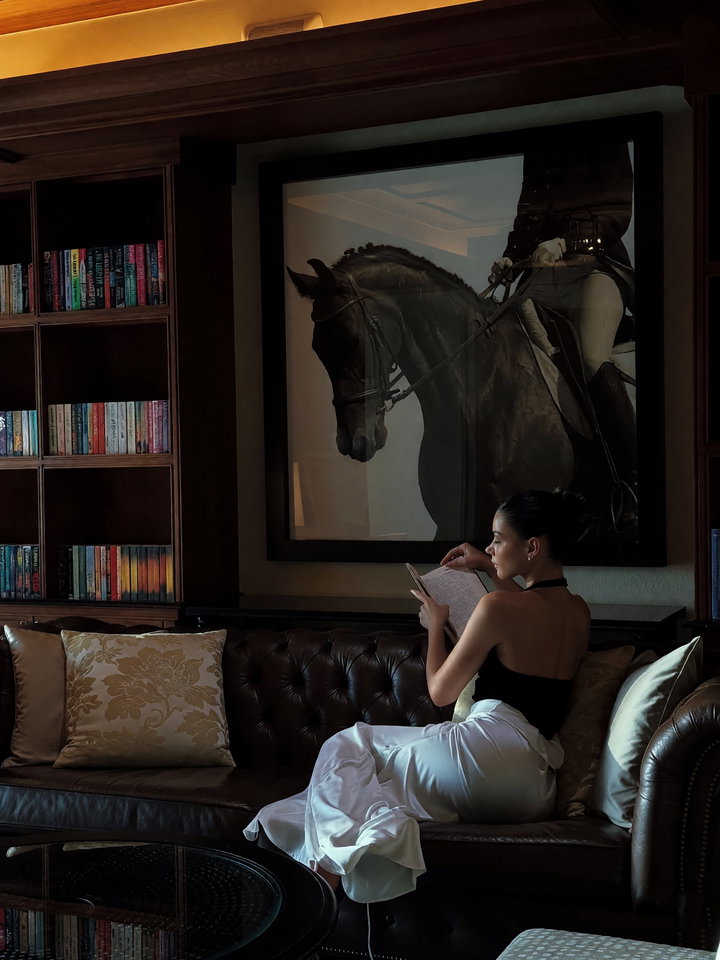 Contemplative Moment in Luxurious Library