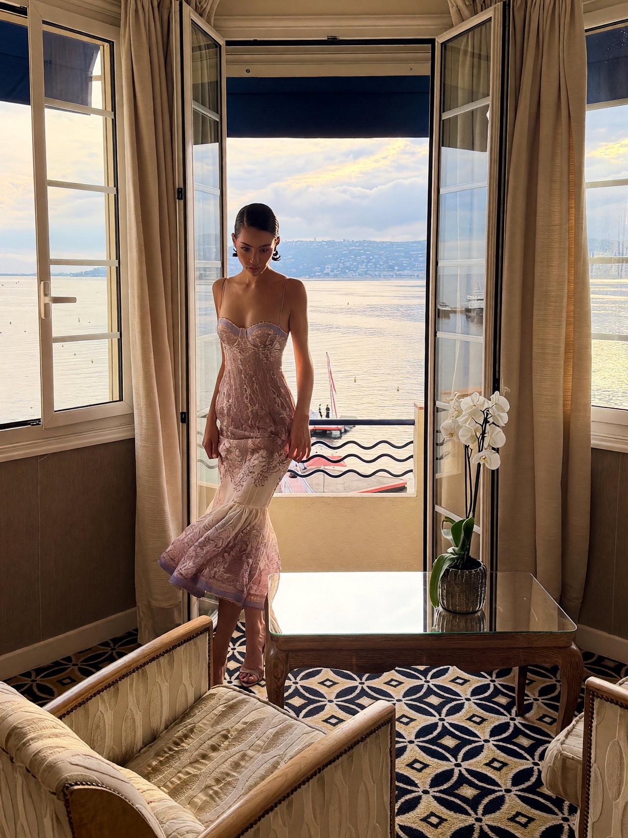 Fashion Model in Elegant Pastel Dress by Beach View