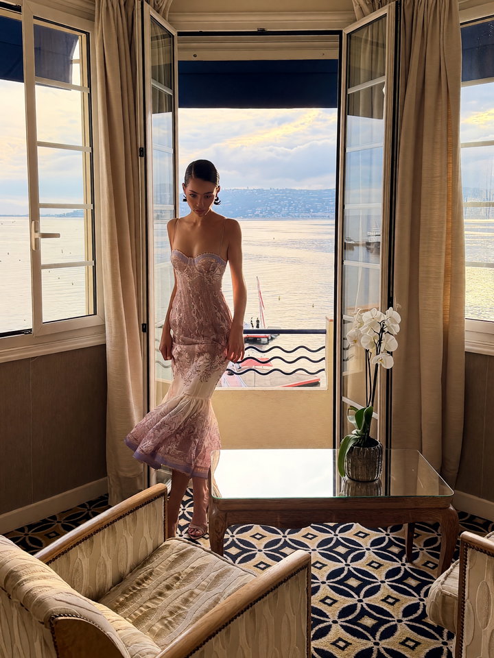 Fashion Model in Elegant Pastel Dress by Beach View