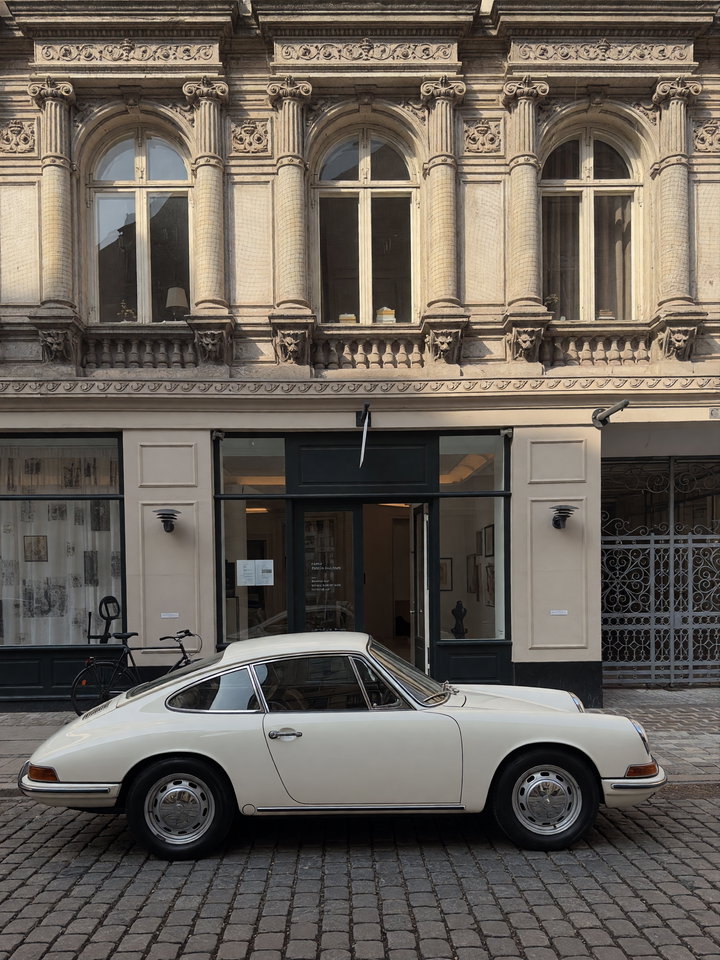 Vintage White Sports Car on Cobblestone Street