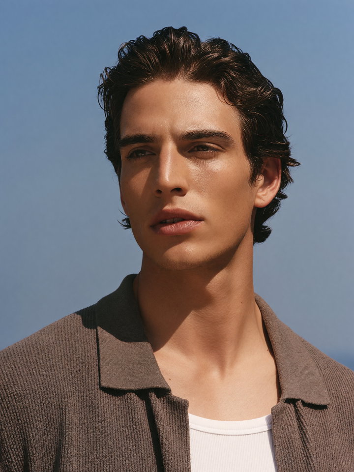 Young Man Portrait Against Clear Blue Sky