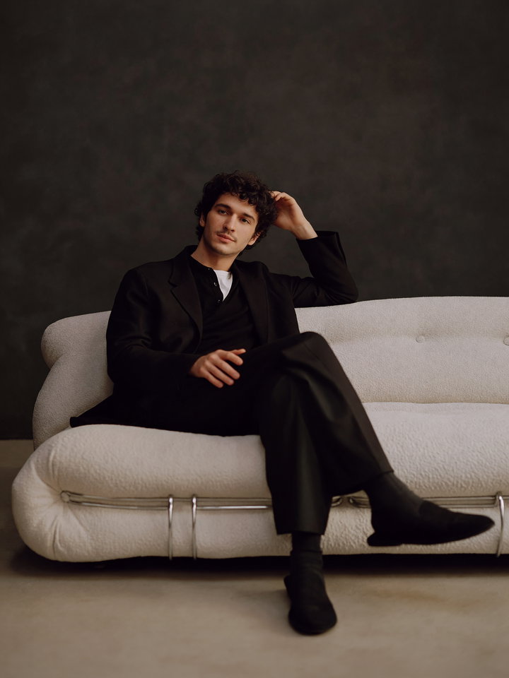 Stylish Young Man on Plush White Sofa