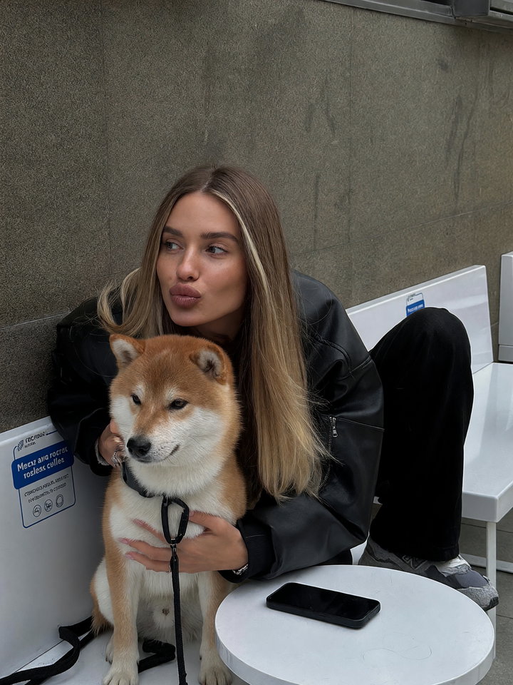 Playful Young Woman with Shiba Inu in Urban Setting