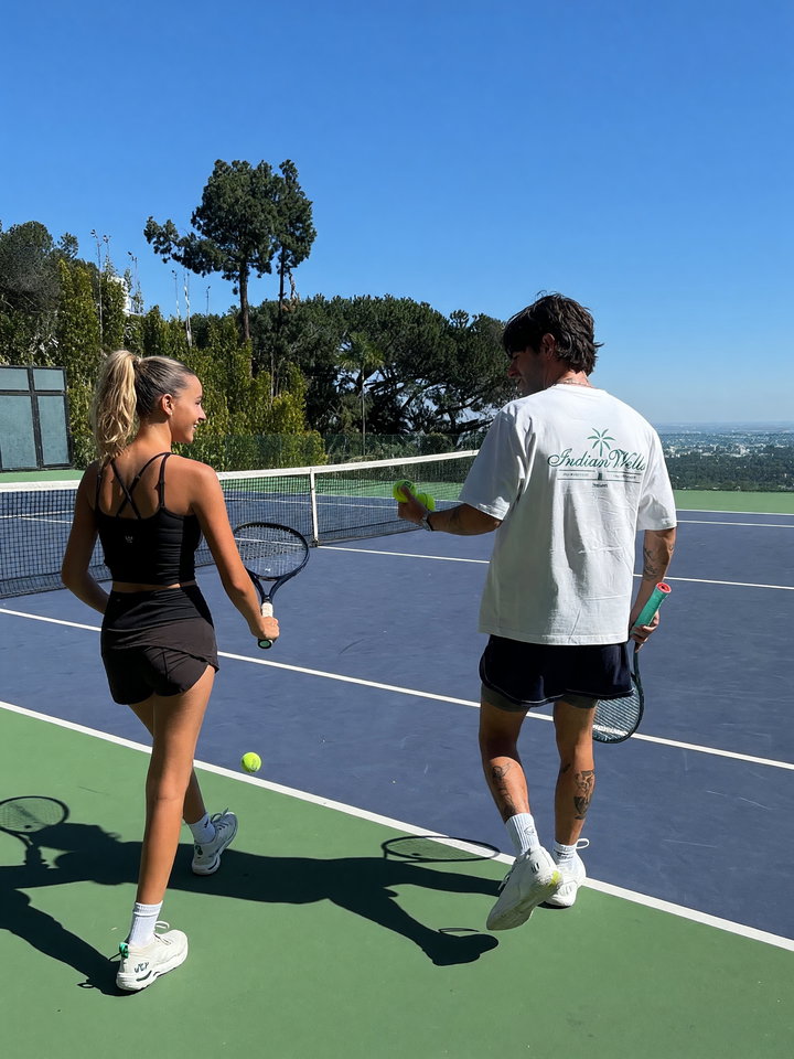Casual Tennis Practice on Sunny Court