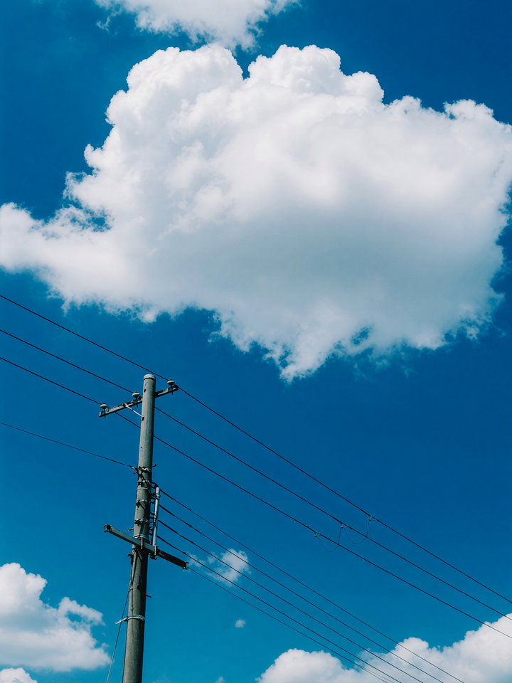 Utility Pole Against Vibrant Blue Sky