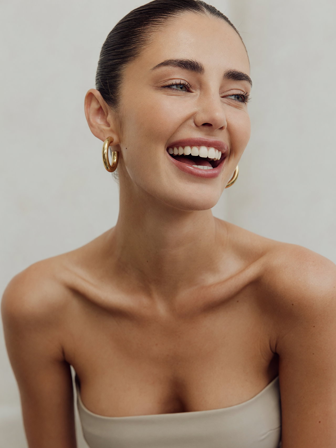 Joyful Young Woman in Neutral Top