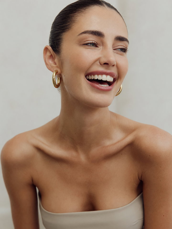 Joyful Young Woman in Neutral Top