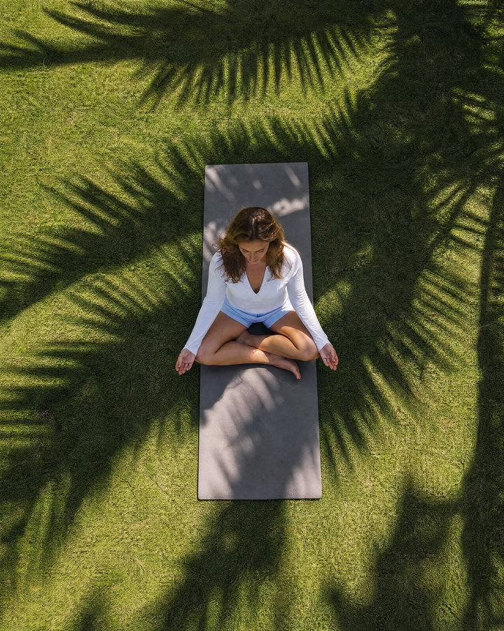 Aerial View of Woman Practicing Yoga on Grass