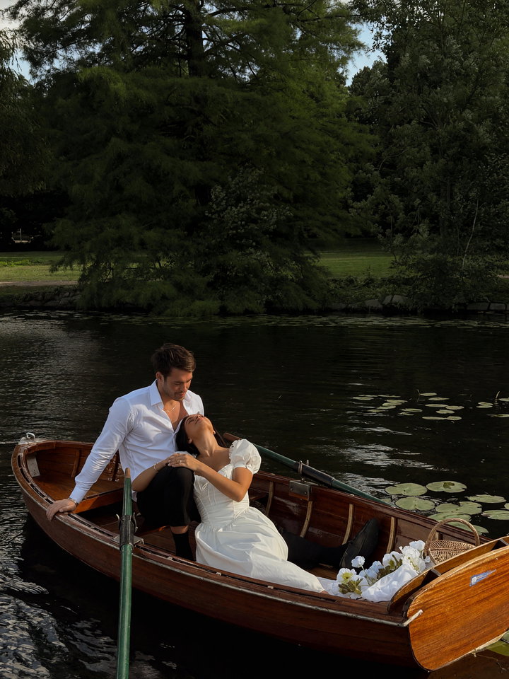 Couple in Wooden Boat on Serene Lake