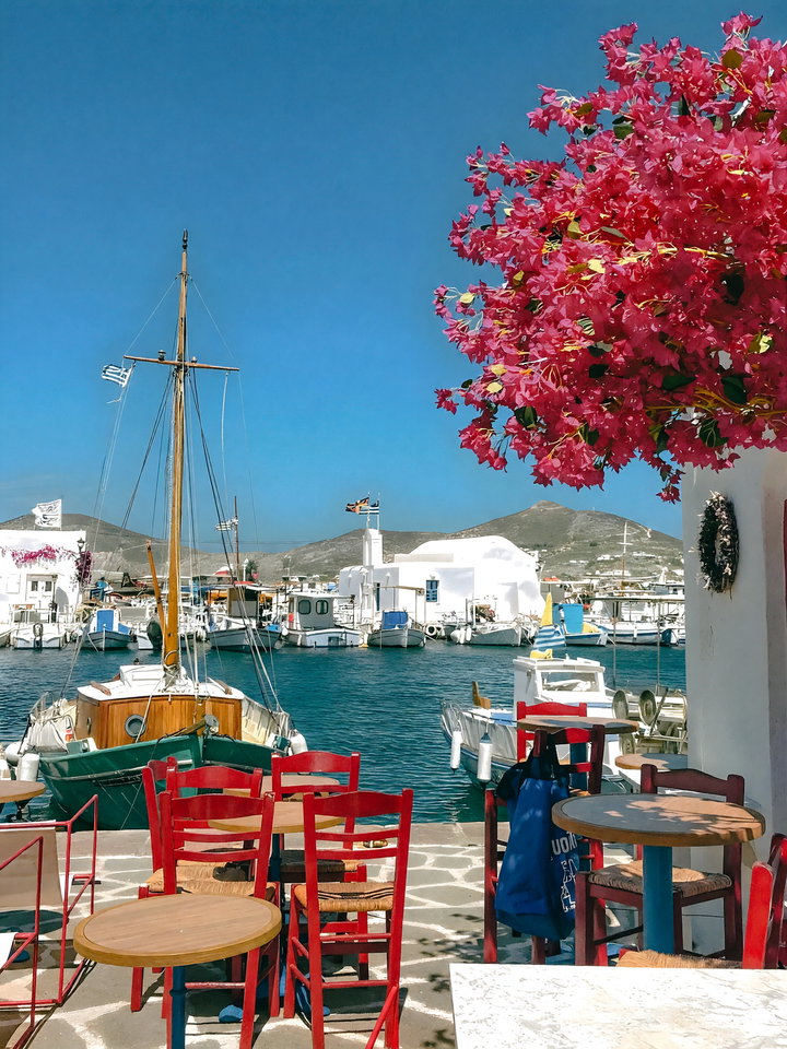 Vibrant Seaside Terrace with Red Chairs