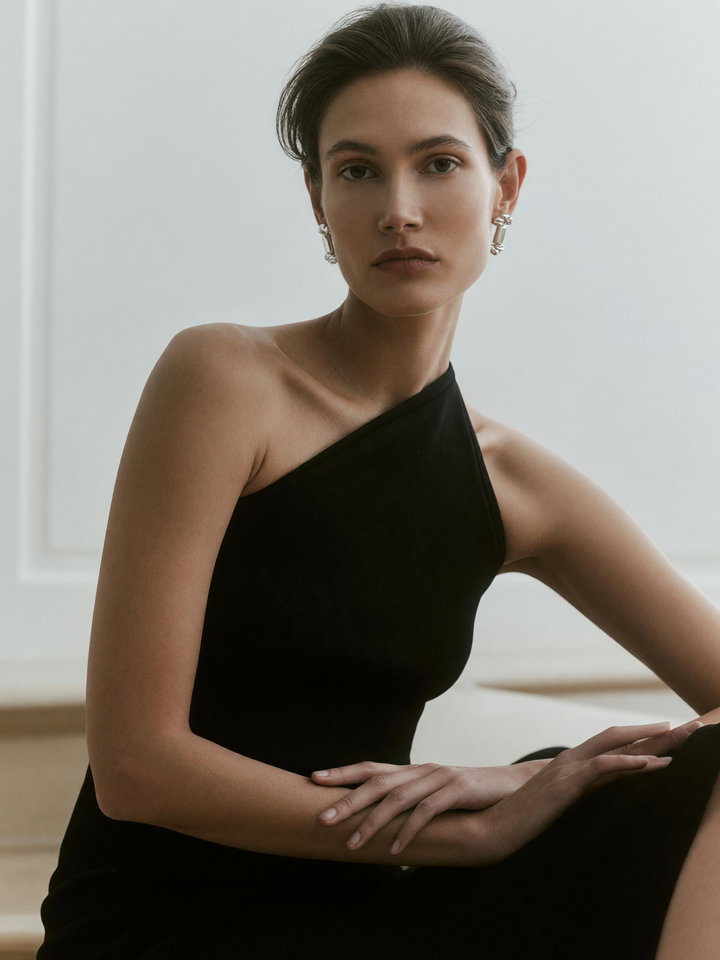 Elegant Young Woman in Black Halter-Neck Dress