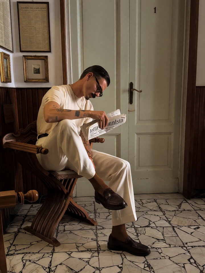 Young Man Reading Newspaper in Vintage Interior