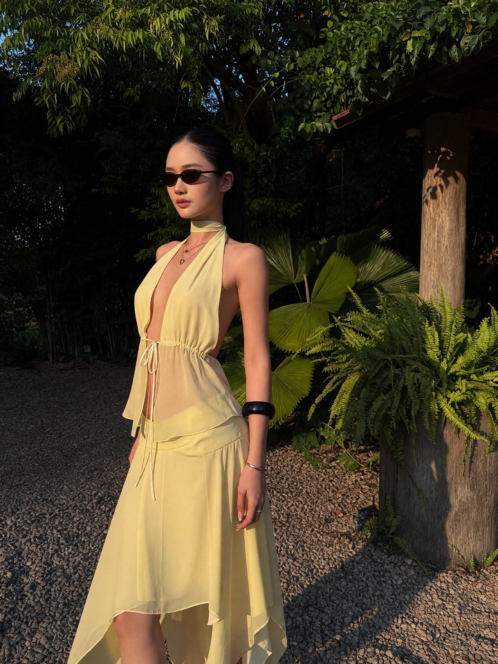 Young Woman in Pale Yellow Dress in Natural Setting