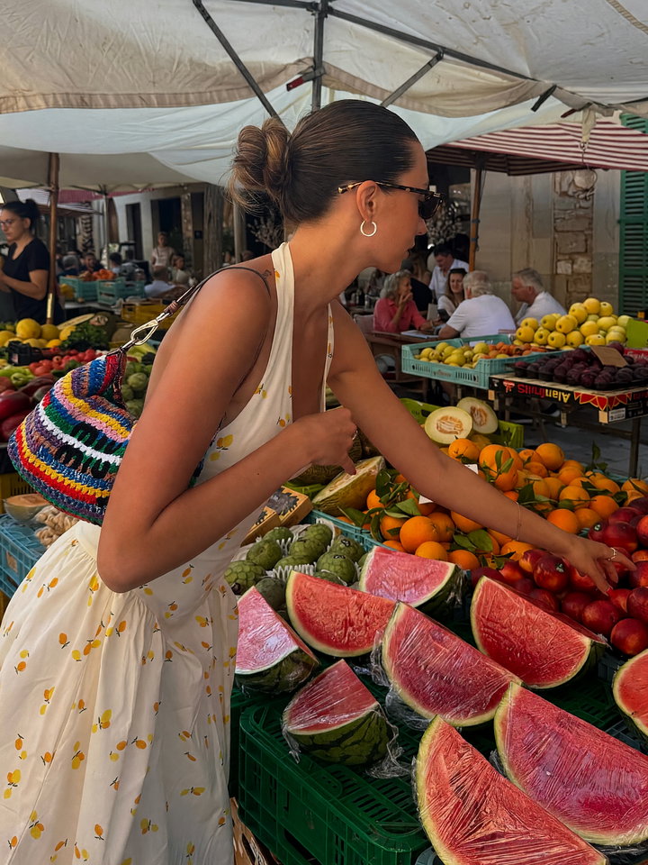 Young Woman Shopping at Vibrant Outdoor Market