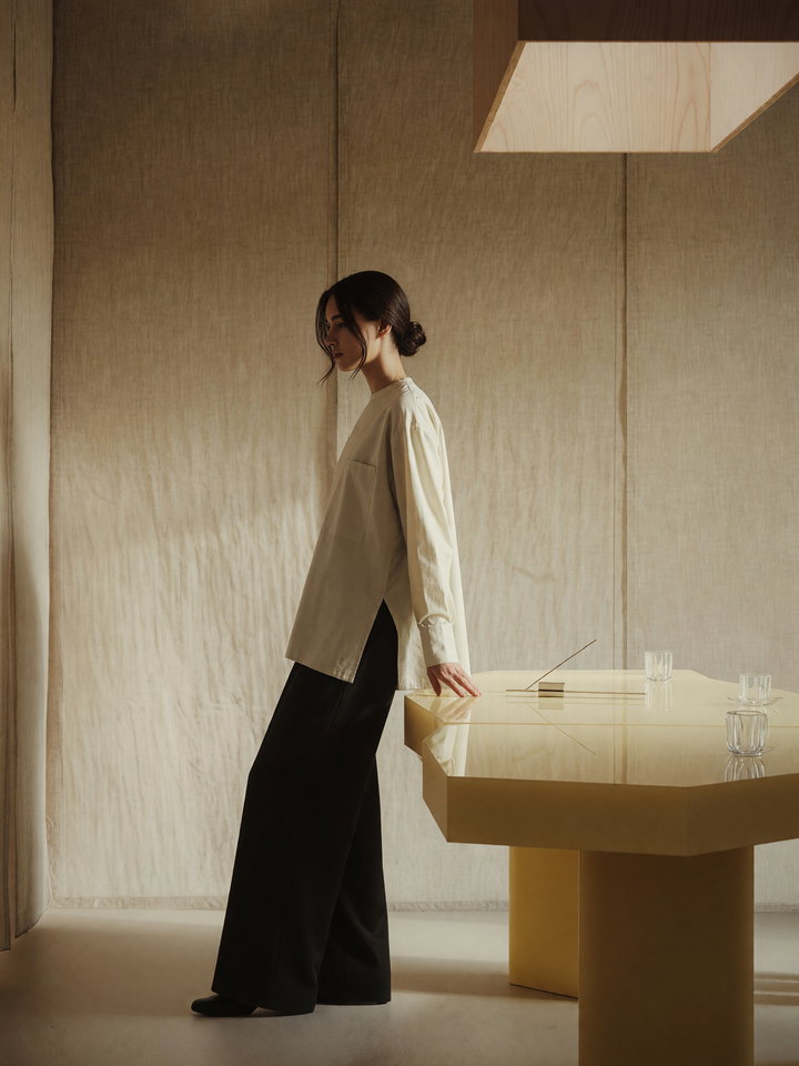 Contemplative Woman in Minimalist Interior