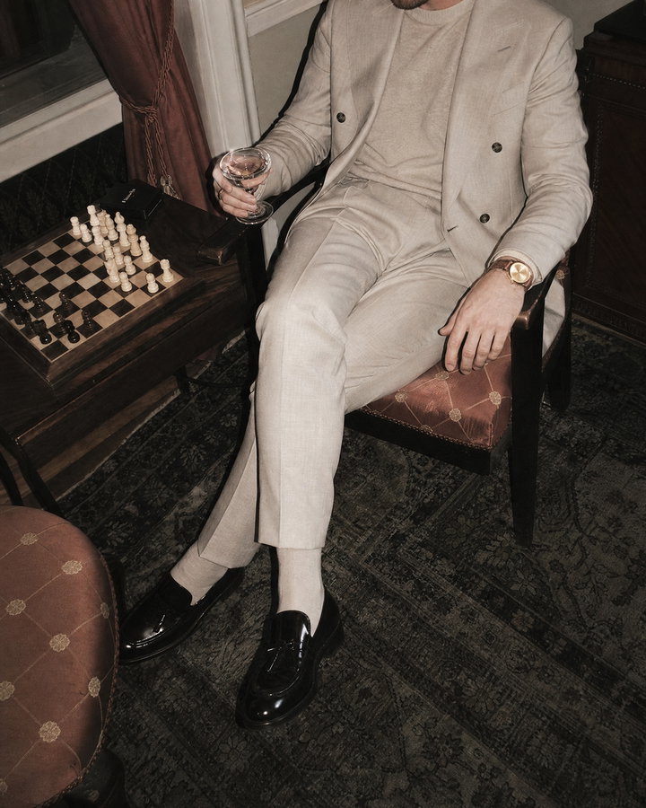 Elegant Man in Tailored Suit with Chessboard