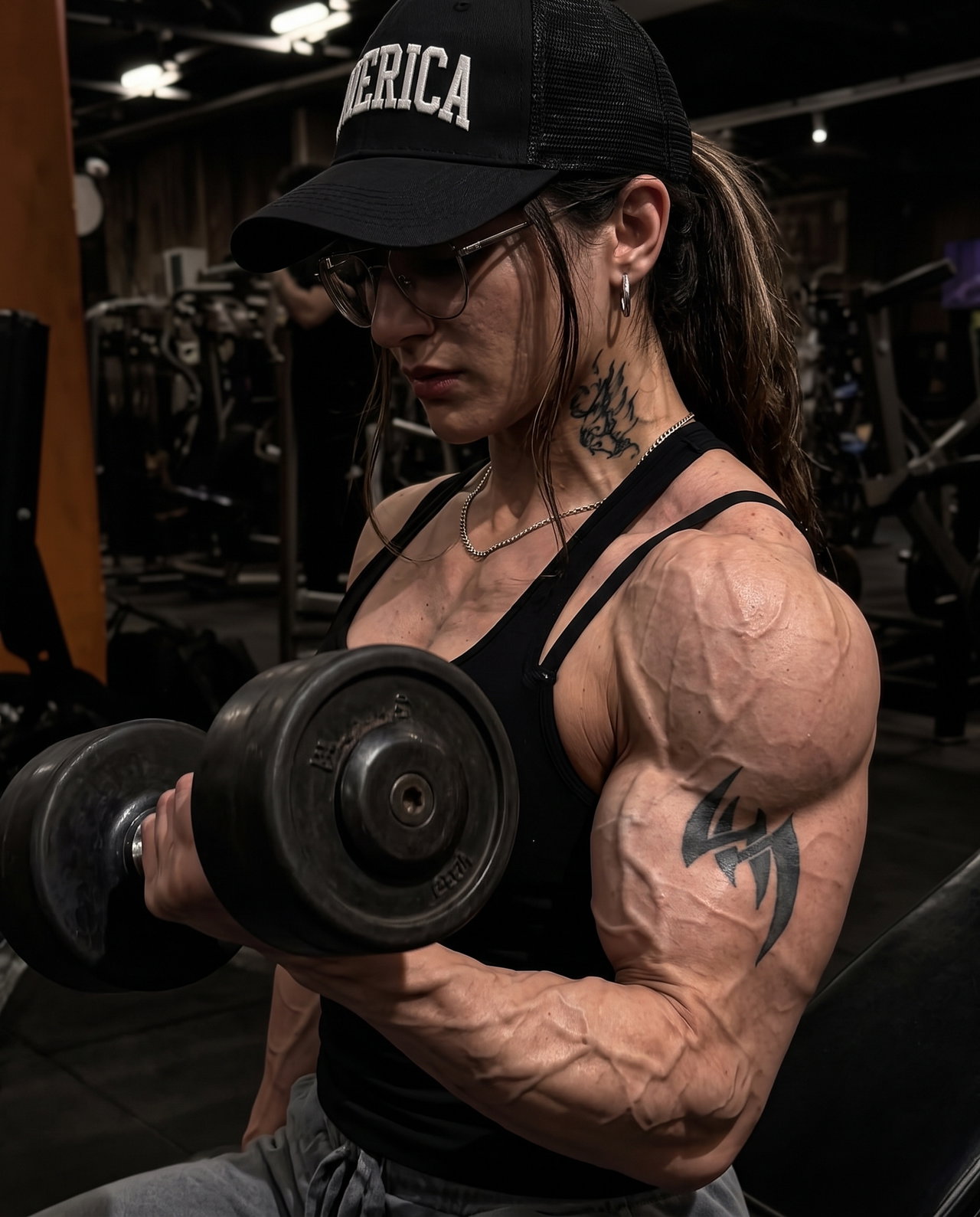 Muscular Woman Lifting Dumbbell in Gym