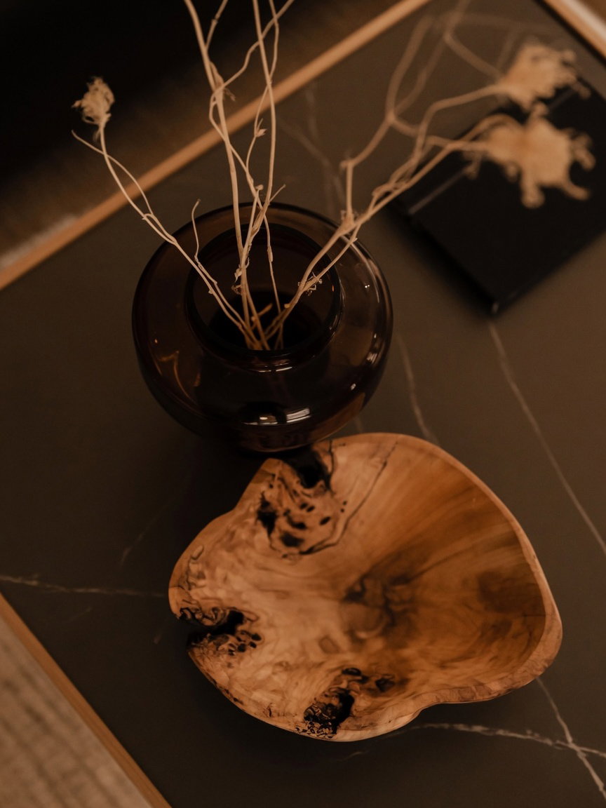 Top-Down View of Wooden Bowl and Amber Glass Vase