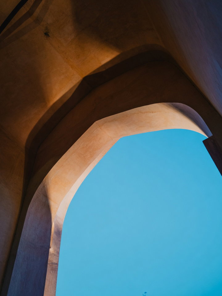Curved Concrete Archway Against Blue Sky