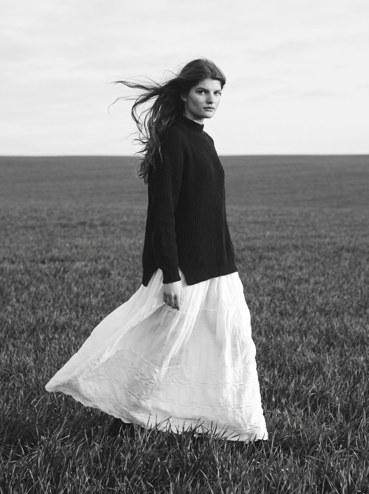 Woman in Windy Field in Black and White