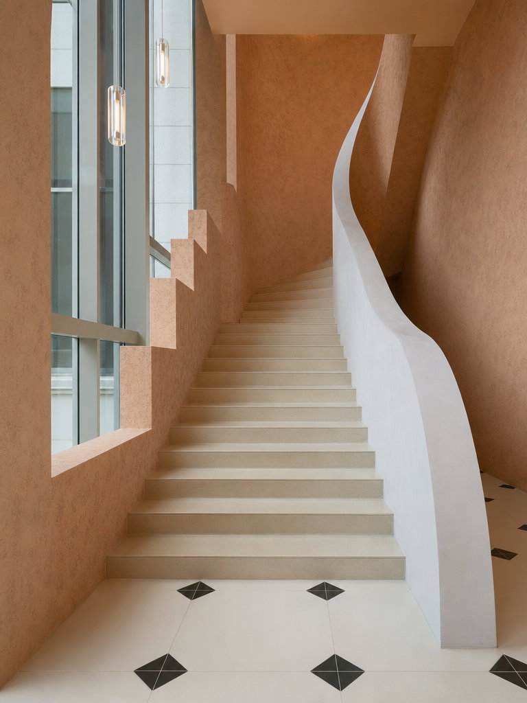 Curved Staircase with Terracotta Walls