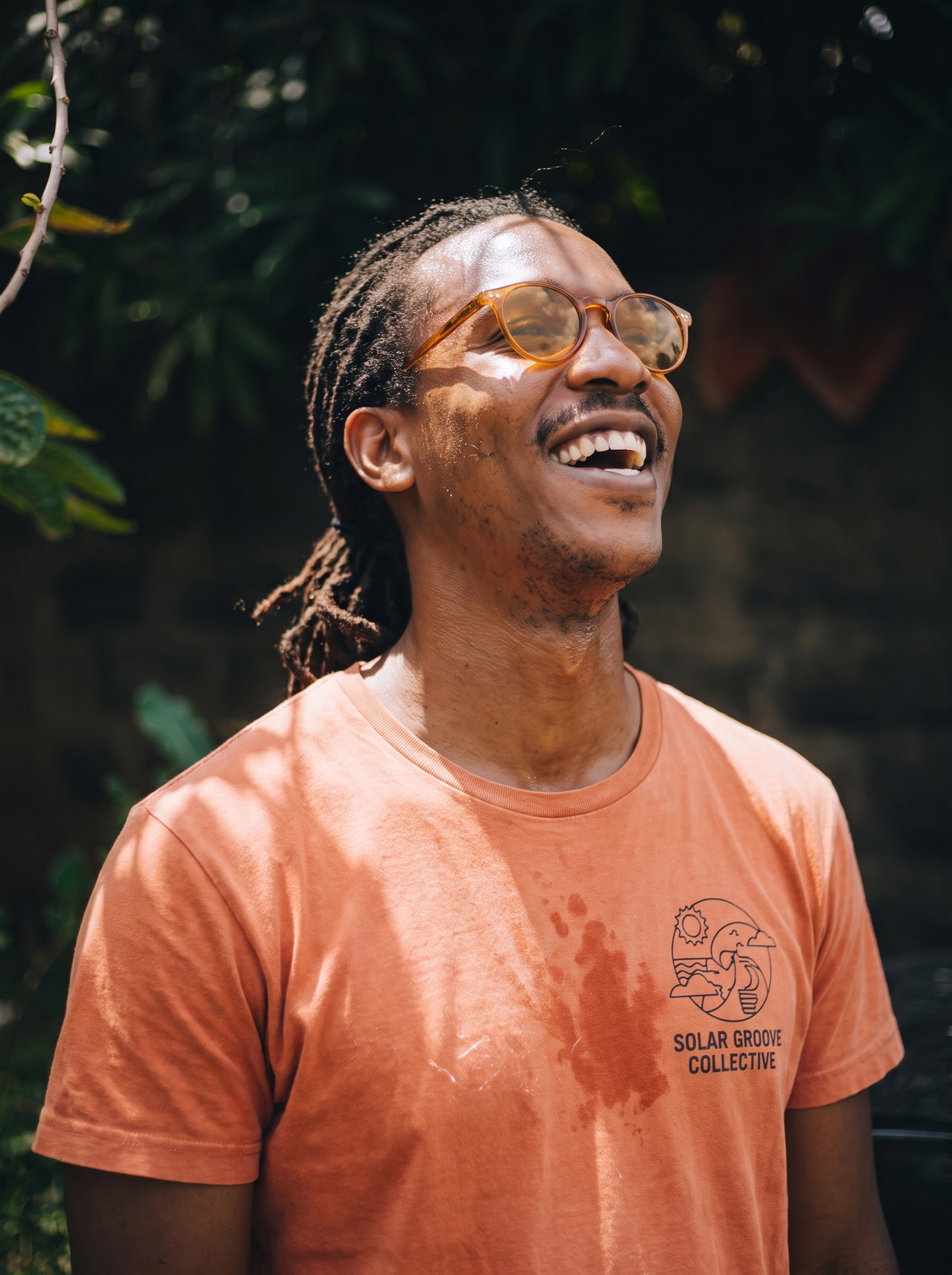 Laughing Man with Short Locs and Amber Glasses