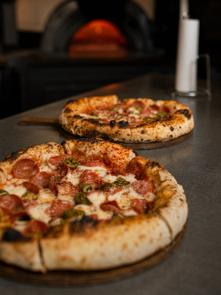 Wood-Fired Pepperoni Pizzas on Counter