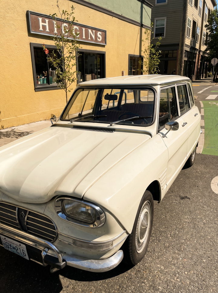 Vintage Cream Estate Car Parked Outside Bar