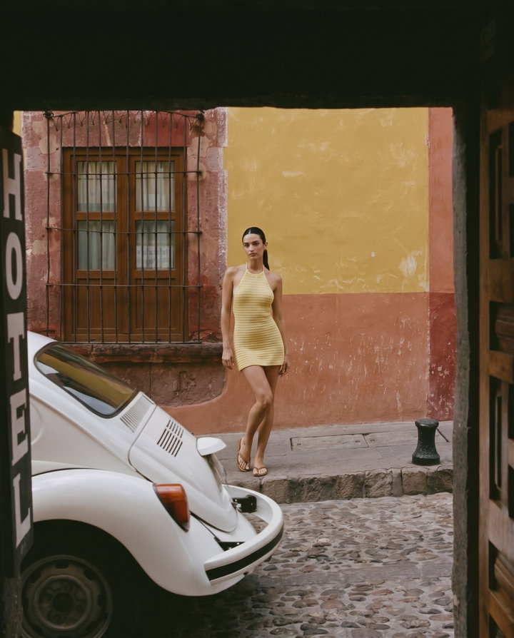 Woman in Yellow Crochet Dress Beside Vintage Car