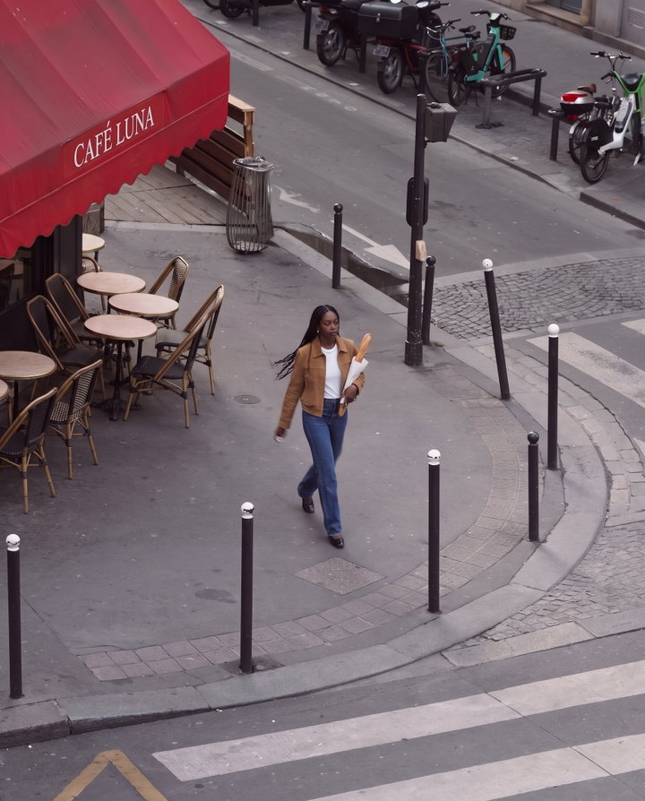 Woman Walking with Baguette in Paris Street Style