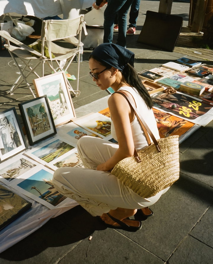 Crouching Woman Browsing Vintage Prints