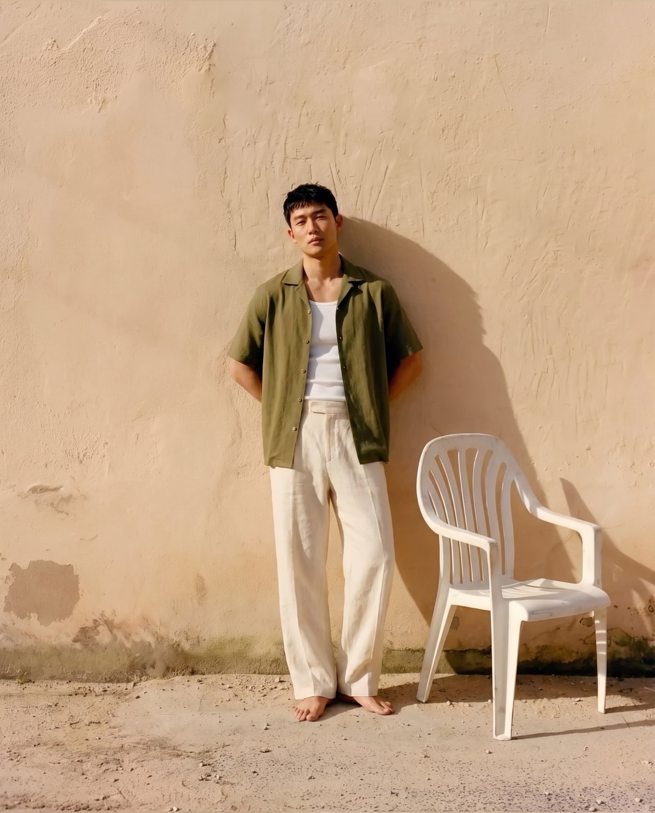 Casual Summer Outfit Against Plaster Wall
