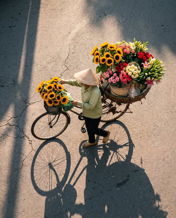 Flower Seller on Bicycle with Sunflowers and Roses