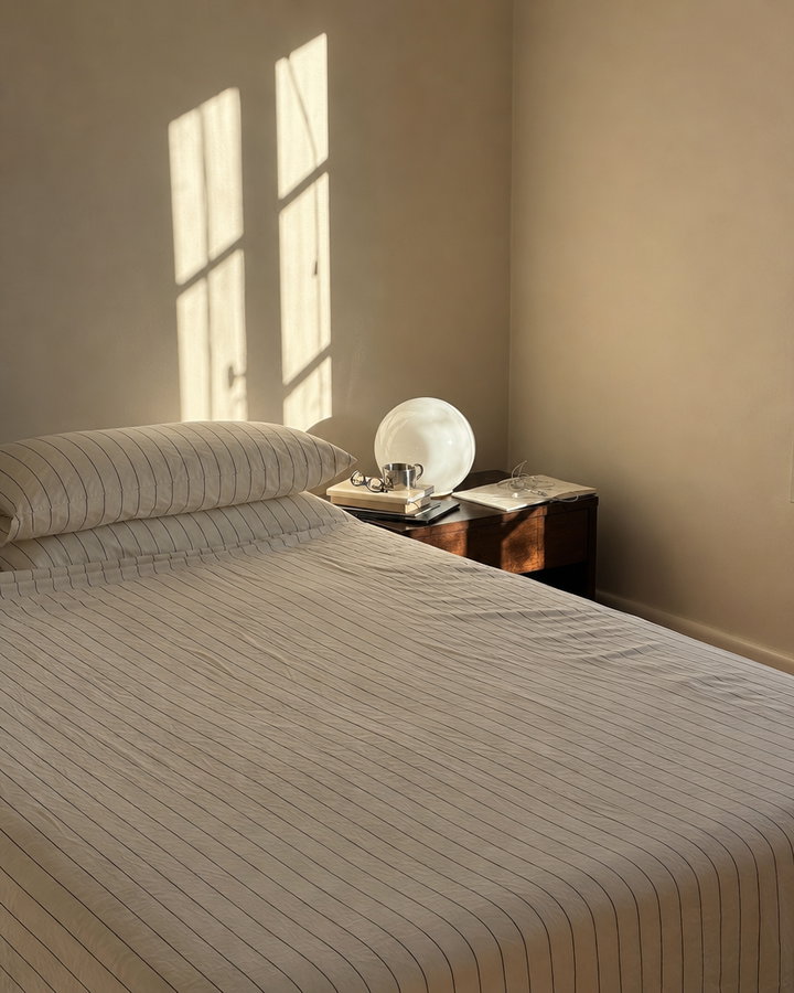Morning Light on Striped Bedding and Nightstand