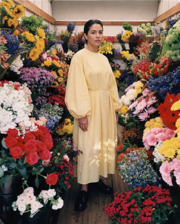 Woman in Yellow Dress Among Flowers