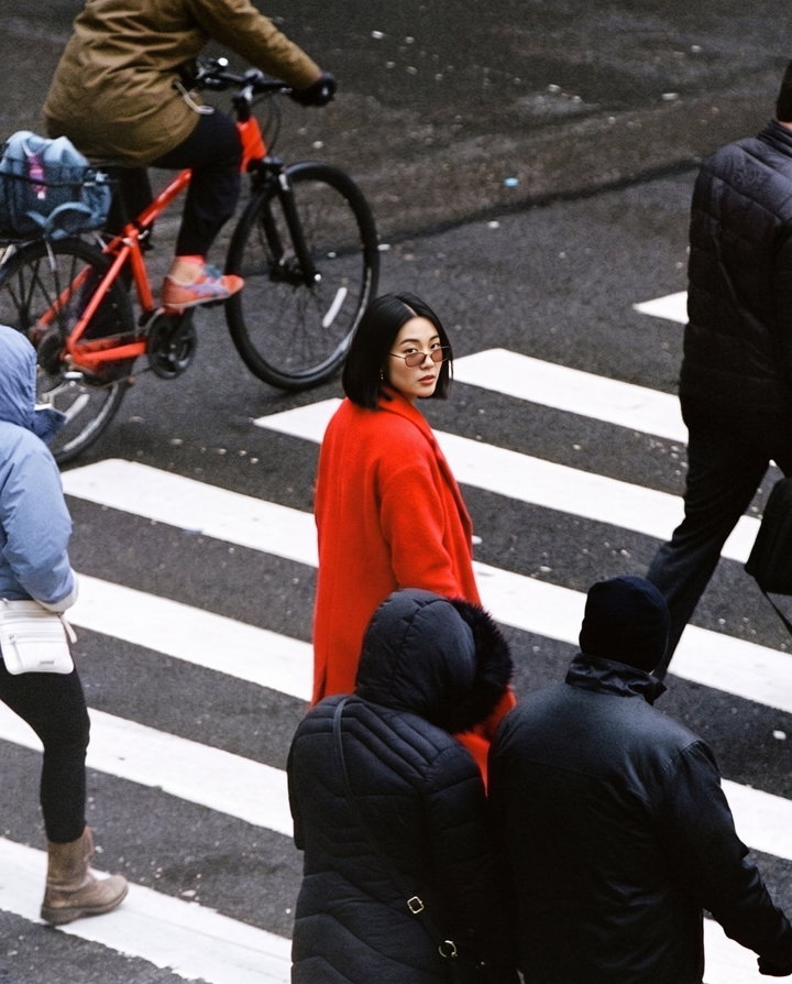 Woman in Red Coat on Pedestrian Crossing