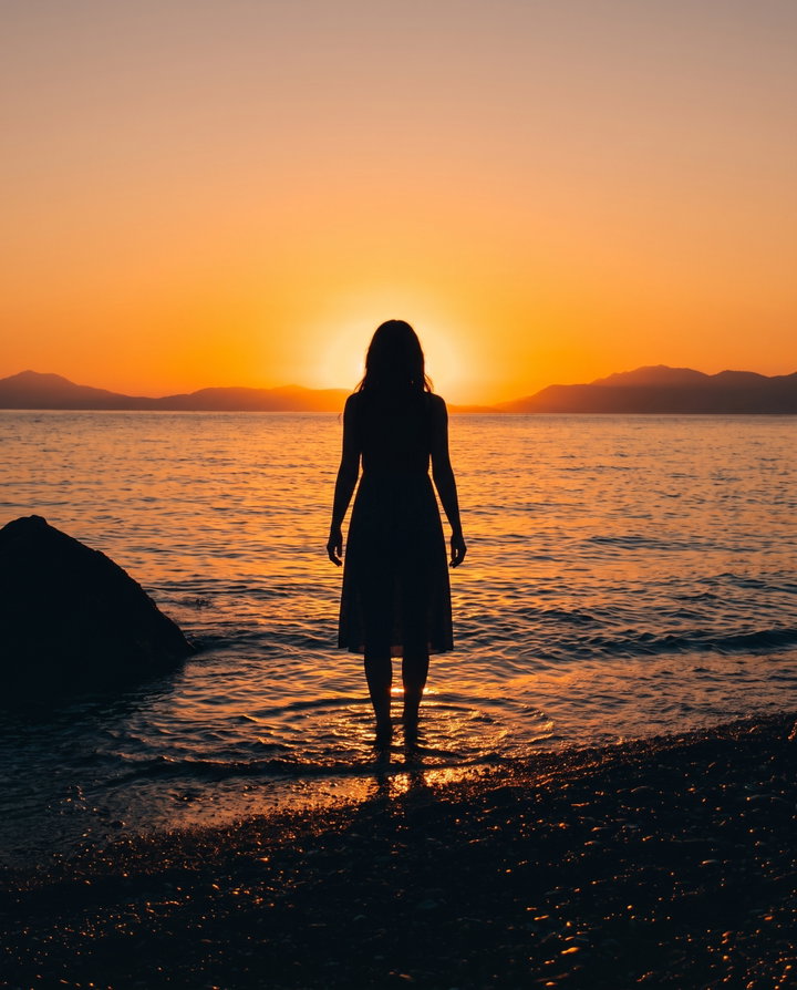 Silhouette of Woman at Sunset by the Sea