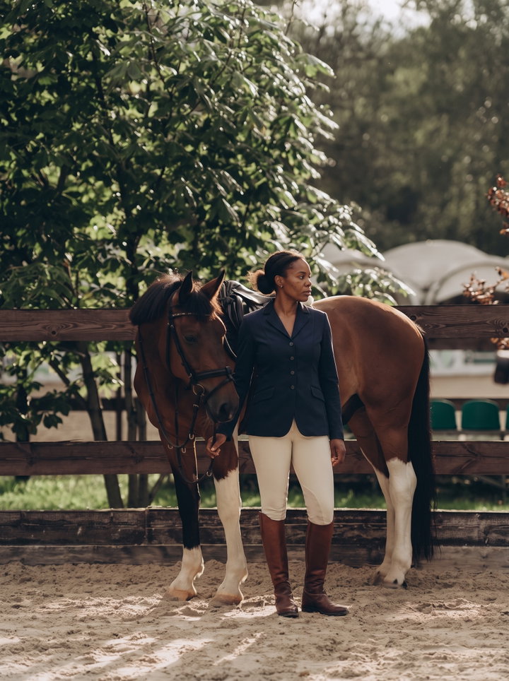 Woman in Classic Riding Outfit Beside Bay Horse