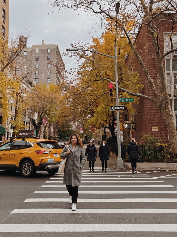 Woman Crossing New York Crosswalk in Autumn