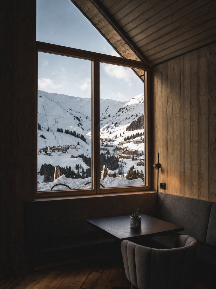 Chalet Window View of Snowy Alpine Village